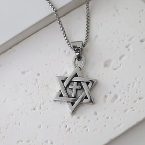 Close-up of hexagram and cross pendant on a high-quality vintage silver box chain