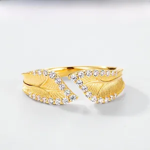 Macro shot of gold leaf ring with brushed texture and pavé set sparkling diamonds