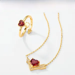 Close-up of S925 gold-plated garnet heart ring and matching necklace set for women
