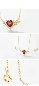 Detail of heart garnet pendant with winged design and white zircon accents in gold plating