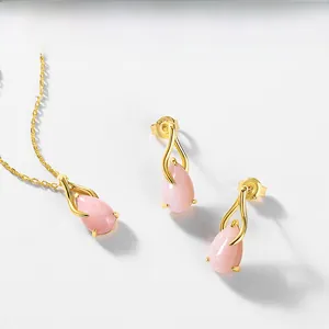Close-up of S925 sterling silver gold-plated earrings with drop-shaped pink opal stone
