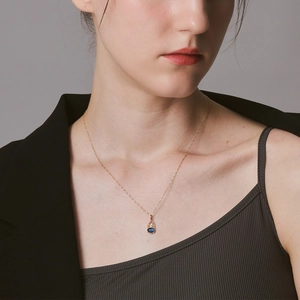 Nahaufnahme einer vergoldeten Silberkette mit einem blauen Lapislazuli-Anhänger
