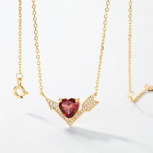 S925 silver gold-plated necklace with a red heart-shaped gemstone and arrow wing details