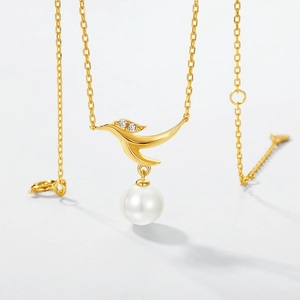 Elegant gold bird pendant necklace with round white pearl and sparkling crystals