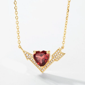 Close-up of S925 gold heart necklace with red garnet and arrow-shaped diamond accents