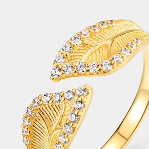 Macro detail of leaf-shaped open ring with vintage brushed texture and shimmering zircons