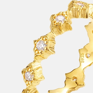 Macro detail of S925 sterling silver gold ring with geometric shapes and clear zircons