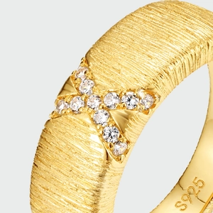 Macro detail of S925 silver gold-plated ring with brushed texture and X-shaped gems