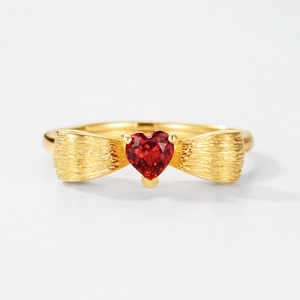 Brushed gold bow ring featuring a heart-shaped red zircon stone for women