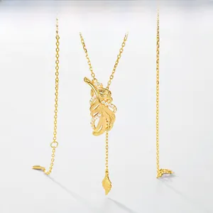 Detail of gold-plated silver leaf necklace with brushed metal finish and zircons
