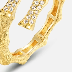 Macro detail of S925 silver bamboo ring with brushed gold finish and sparkling zircons