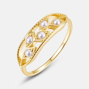 S925 silver gold-plated ring with hollow leaf design and five white pearls on white background