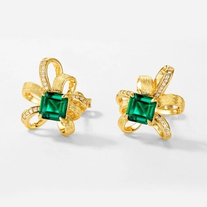 Vintage ribbon earrings in gold finish with square emerald gemstone and white diamonds