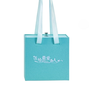 Textured blue jewelry gift box with satin ribbon handle and silver pull knob accents