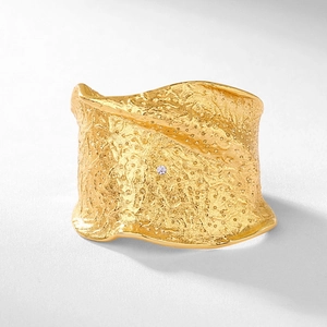 Irregular textured gold S925 silver ring with a sparkling center diamond detail