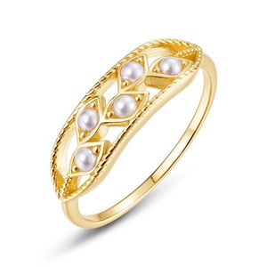 Retro hollow gold ring with shell pearls and twisted rope texture on white background