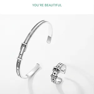 Detail view of vintage 925 silver belt buckle ring and cuff set with floral engraving