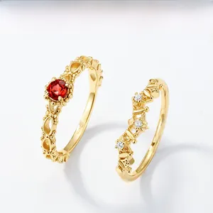 Detailed close-up of S925 vintage gold lace ring set with round red garnet stone