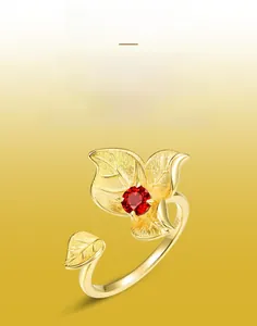 Macro detail of S925 sterling silver ring with brushed gold texture and ruby stone