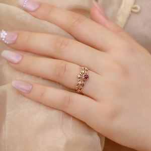 Vintage rose gold open ring with red garnet stone and intricate lace filigree detail