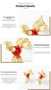 Detailed macro shot of brushed gold S925 sterling silver feather earring with red agate stone