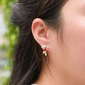 Vintage gold S925 sterling silver stud earrings with red agate leaf design on a model