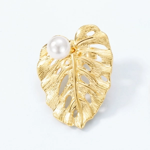 Brushed gold monstera leaf earrings with white pearl accent in minimalist nature style
