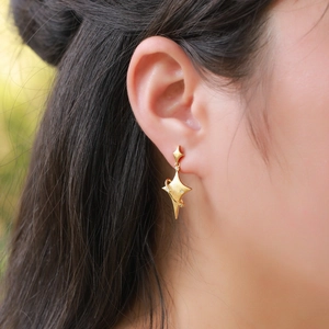 925 silver brushed gold star planet earrings with tassel drops worn by a female model