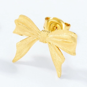 Elegant gold bow earrings with a brushed matte finish and smooth minimalist texture