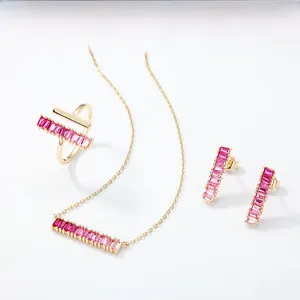 Macro detail of 18K gold plated jewelry set with pink rectangular gradient gemstones