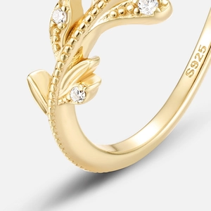 Detail of S925 sterling silver leaf ring with gold plating and white stones