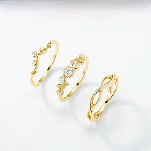 Detail of three-piece S925 sterling silver gold rings set with natural white crystal stones