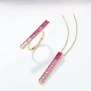 Close-up of S925 silver necklace and ring with baguette-cut pink gradient gemstones