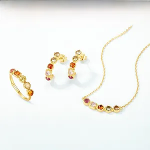 Macro detail of multi-color gemstone jewelry set with gold finish and vibrant stones
