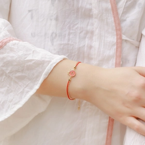 Cute S925 silver red rope bracelet featuring a pink enamel pendant with a gold crown charm