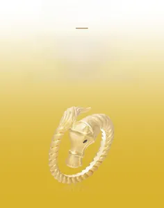 Detailed view of horse head ring featuring a brushed gold finish and spiral band design