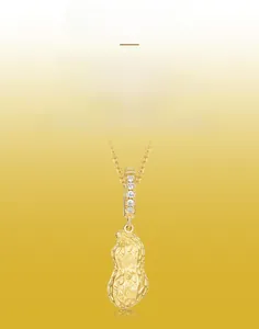 Detailed view of brushed gold peanut pendant with sparkling zircon inlays on top