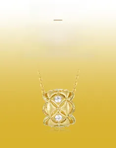 Macro shot of gold-plated brushed pendant with hollow cross pattern and sparkling zircons