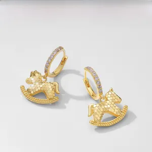 Detail of S925 sterling silver rocking horse earrings with honeycomb texture and zircons