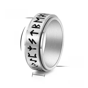 Detail of 8mm rotating titanium steel ring with engraved Nordic runes and brushed finish