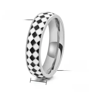 Detail view of 6mm titanium steel ring featuring black and white checkerboard enamel