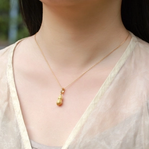 S925 sterling silver peanut necklace with red agate pendant worn by a model in warm light