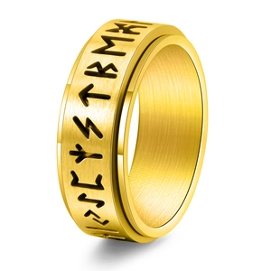Detailed view of golden brushed stainless steel spinner ring with Nordic Viking runes