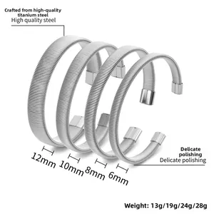 Macro detail of four silver titanium steel spring bracelets in 6mm to 12mm widths