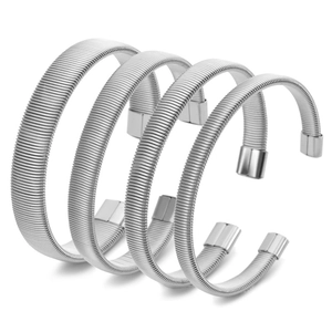 Set of four silver elastic C-shaped bracelets with detailed coil texture and polished ends