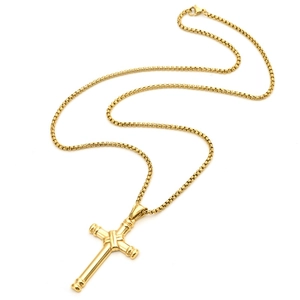 Detail of polished gold stainless steel cross pendant with high-quality metal link chain