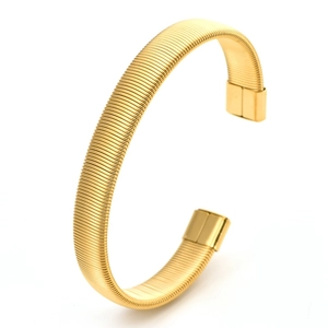 Detail of golden Tubogas flexible cuff bracelet featuring helical metal textures
