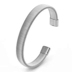 Close-up of silver C-shaped cuff bracelet featuring fine industrial threaded texture