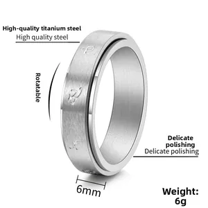 Detailed view of 6mm black rotating titanium steel ring with brushed finish and engraving