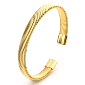 Macro shot of 18K gold C-shaped cuff bracelet with detailed flexible spring-like texture